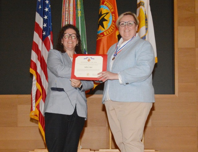 CECOM Integrated Logistics Support Center Executive Director Nicole D. Osaghae congratulates Kellie Roth and awards her with a Civilian Service Achievement award and medal.