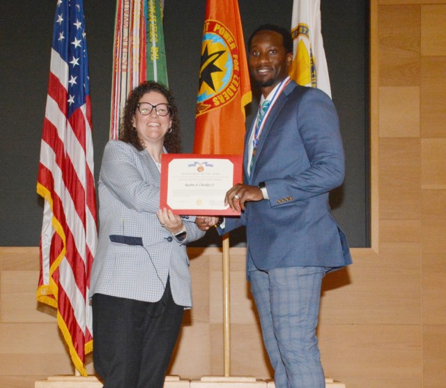 CECOM Integrated Logistics Support Center Executive Director Nicole D. Osaghae congratulates Rueben Checkley and awards him with a Civilian Service Achievement award and medal.