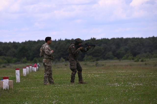 U.S. Army Sgt. Michael Rojas, a cavalry scout with C Troop, 2nd Squadron, 106th Cavalry Regiment, Illinois Army National Guard, observes as a Polish Territorial Defence soldier engages targets on a range near Toruń, Poland, June 7, 2025. The...