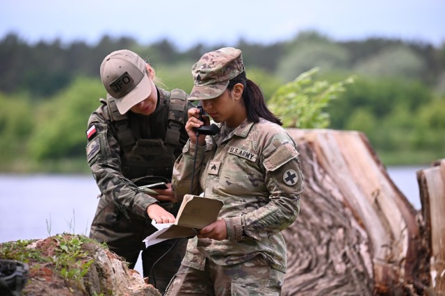 U.S. Army Sgt. Joseline Sosa, a forward observer with 1st Battalion, 178th Infantry Regiment, Illinois Army National Guard, receives information from her Polish counterparts during training on remote observer techniques in Toruń, Poland, June 6,...