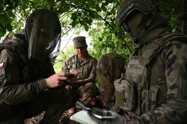 U.S. Army Sgt. Joseline Sosa, a forward observer with 1st Battalion, 178th Infantry Regiment, Illinois Army National Guard, relays information to her Polish counterparts during training in remote observation techniques in Toruń, Poland, June 6,...