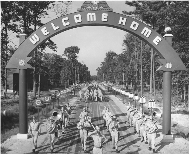 Troops of the 10th Mountain Division march under the Welcome Home Arch, Hampton Road, Virginia, upon their return home from Italy. The division inactivated at Camp Carson, Colorado, on Nov. 30, 1945. (NARA photo)