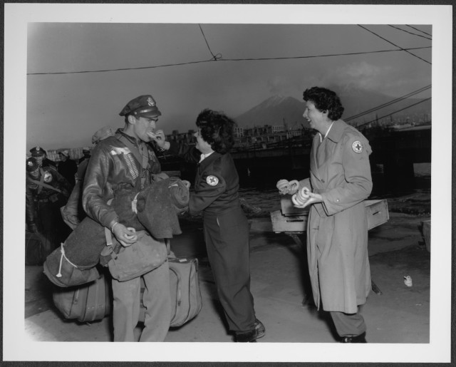 Red Cross volunteers feed donuts to Soldiers with the 10th Mountain Division in Naples, Italy, during World War II. (Robert Lee Olen Collection, Library of Congress)
