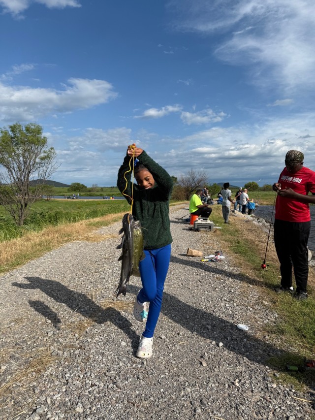 A young participant holds up a stringer of fish at Fort Sill’s 39th annual Kids Fishing Derby.