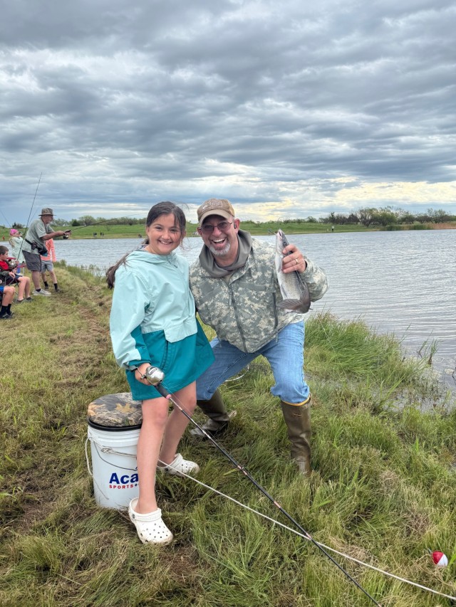 Greg Marcum and his granddaughter Ansley show off their catch at Fort Sill’s 39th annual Kids Fishing Derby,