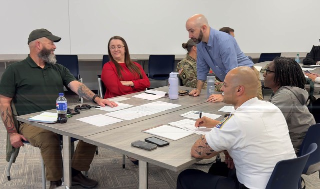Jerome Deniz, Fort Belvoir Garrison emergency manager, center, discusses next steps with representatives from DPTMS, Safety Fire and Safety offices during a hurricane response tabletop exercise at the DHR Classroom, June 3. The exercise helped all...