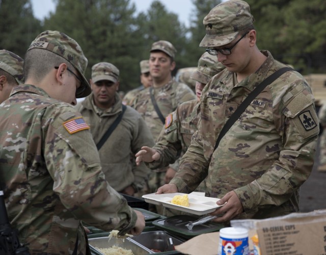 Soldiers of G-Co., 29th Brigade Support Battalion, Arizona National Guard, line-up to eat the breakfast prepared by their own award-winning 92Gs, Food Service Specialists, on Camp Navajo, Bellemont, Ariz., July 14.
...