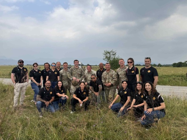 AVIANO AIR BASE, Italy – AMICI participants pose with paratroopers from 1st Battalion, 503rd Infantry Regiment on Juliet drop zone June 23, 2025.