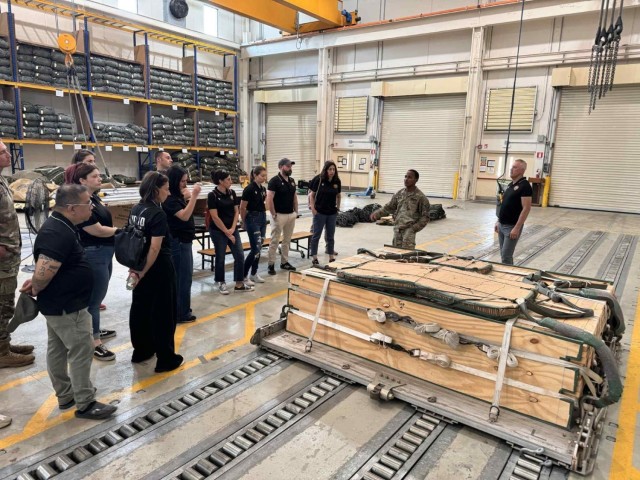 AVIANO AIR BASE, Italy – A U.S. Army rigger from Kilo Company, Brigade Support Battalion, 173rd Airborne Brigade briefs AMICI participants on cargo rigging procedures during a tour of the Parachute Activity Headquarters Aviano June 23, 2025.