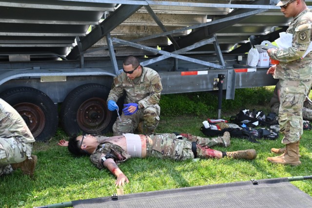 Soldiers, Marines, and Airmen, in moulage, replicated wounded military members, as both Air Force and Army medics treated the injured and prepared them for transport.