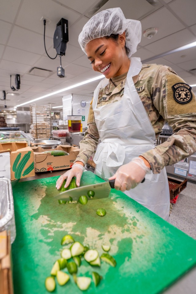 U.S. Army 1st Lt. Alma Cooper, the reigning Miss USA, assigned to the U.S. Army Recruiting Command, prepares food while volunteering at the DC Central Kitchen in Washington, D.C., Dec. 11, 2024.  The volunteer opportunity was part of several...