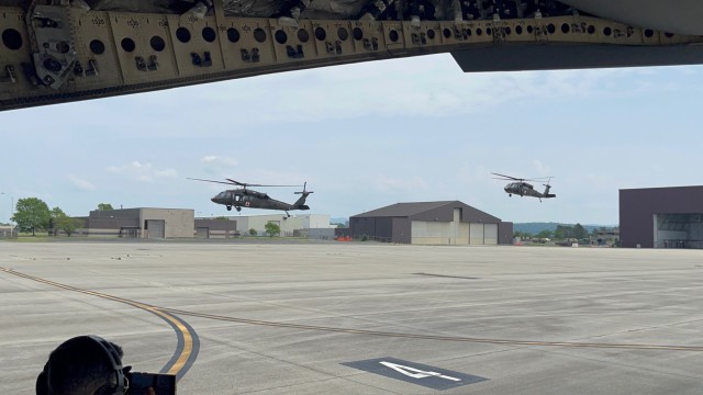 UH-60L Blackhawk medical evacuation helicopters make their approach to the landing zone to transport (simulated) injured military members to the awaiting C-17 Globemaster.