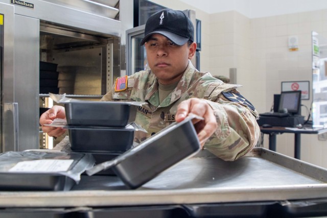 Spc Roman, a culinary specialist, at the Raptor Warrior Restaurant takes account of meal prep items for the day on Joint Base Lewis-McChord, Wash. on March 4, 2024. The meals served to the Soldiers who enter the Raptor Warrior Restaurant are...