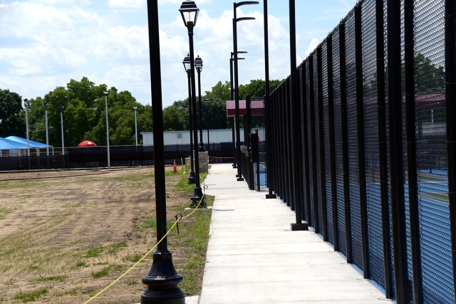 A walking path wraps around completed pickleball courts, on the right, and a rope barrier marks areas to stay off of, including an in-progress soccer field, on the left, at Grant Park at Fort Leavenworth, Kansas. Photo by Emilio Gutierrez/Fort...