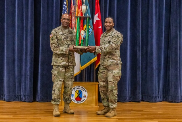 Gen. Gary M. Brito, U.S. Army Training and Doctrine Command commanding general, presents the Brig. Gen. David H. Stem Award to Capt. Ragille Sims, 209th Military Police and the 904th Military Working Dog Detachments commander for outstanding...