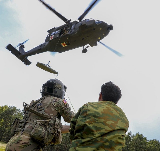 During Exercise Regional Cooperation 25 (RC 25), U.S. Army and Tajikistan partners practice hoisting a training dummy into a UH-60 Black Hawk during a medical evacuation exercise at Camp Edwards, Massachusetts, on June 25, 2025. RC 25 is an...