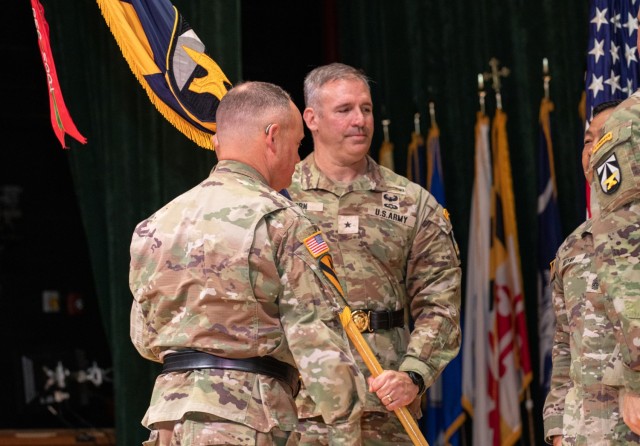 Brig. Gen. Robert Born, the U.S. Army Combat Capabilities Development Command, or DEVCOM, incoming commanding general, center, receives the DEVCOM guidon from Lt. Gen. Miles Brown, the Army Futures Command deputy commanding general, June 27, 2025,...