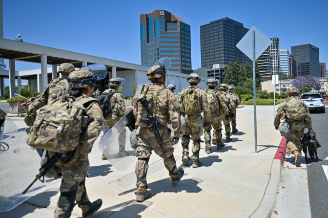 U.S. Army Soldiers with Alpha Company, 1st Battalion, 184th Infantry Regiment, California Army National Guard, arrive at the Wilshire Federal Building in Los Angeles, June 22, 2025. About 100 Soldiers deployed to the site to assist U.S. Marines in...