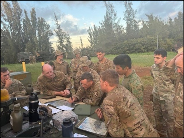 A battalion commander from the 25th Infantry Division conducts a map rehearsal with his company commanders in preparation for a follow-on mission during a recent JPMRC rotation.