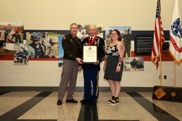 Col. Scott J. Smith (left), Master Sgt. Thomas C. Holk (center) and Alicia Holk (right)