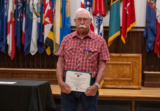 Nelson Allen poses with his Purple Heart Medal June 27 in Lincoln Hall Auditorium.