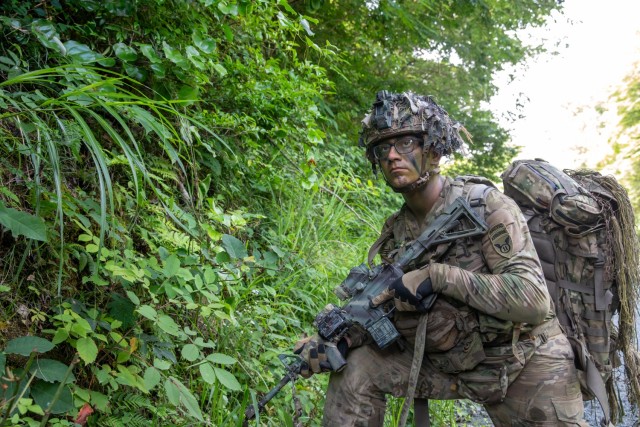 U.S. Army Spc. Gabriel Lentz assigned to Reconnaissance Platoon, Headquarters and Headquarters Company (HHC), 1st Battalion, 5th Infantry Regiment, 11th Airborne Division, provides security along a cliffside at Aibano Training Area, Japan, July...