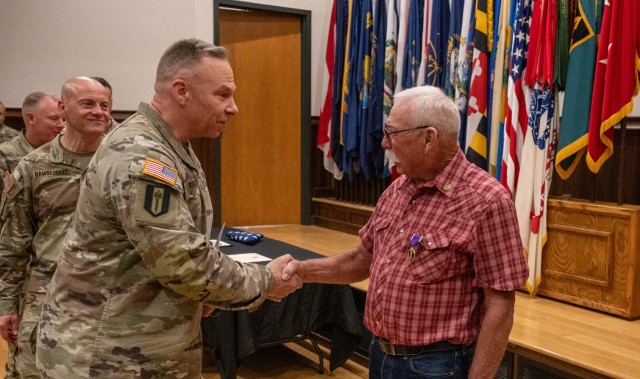 Soldiers line up to shake hands with Nelson Allen following his Purple Heart Medal ceremony June 27 in Lincoln Hall Auditorium. Allen received the medal 54 years after his gun truck was struck by two B40 shoulder-fired rockets, destroying the...