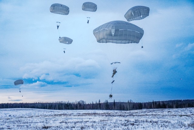 U.S. Army Soldiers assigned to the 1st Battalion, 501st Parachute Infantry Regiment, 11th Airborne Division, descend into Malamute DZ, marking the beginning of the two-day training operation, Geronimo Storm, on December 11, 2024.