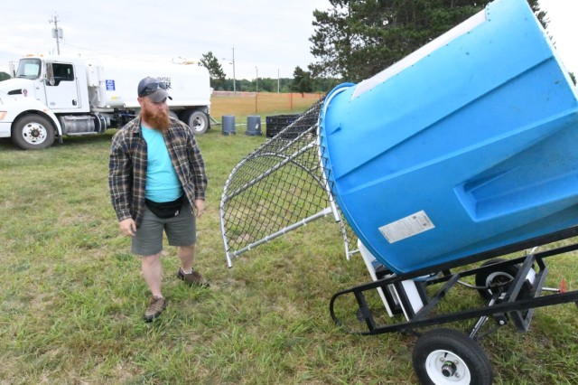 Dan Degrie, Magrath Sports Complex manager, empties the dunking booth and prepares to return it back to Outdoor Recreation during recovery operations on Division Hill on June 27, the morning after Mountainfest 2025. (Photo by Mike Strasser, Fort...