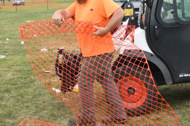 Robert Ashley, with the Directorate of Public Works Roads and Ground Branch, recovers some of the roughly 13,000 feet of fencing used throughout Division Hill for Mountainfest 2025. (Photo by Mike Strasser, Fort Drum Garrison Public Affairs)