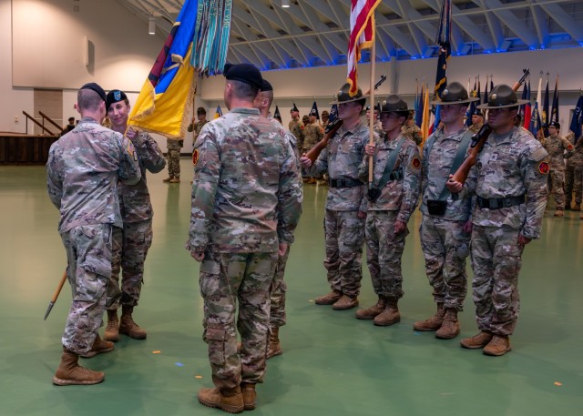 Incoming 3rd Chemical Brigade Commander, Col. Kirsten McFarland, accepts the unit guidon from U.S. Army Chemical, Biological, Radiological and Nuclear School Commandant Col. Alexander Lovasz during a change-of-command ceremony July 1 in Nutter...