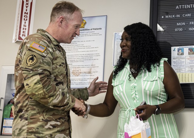 Col. Rich Bendelewski , U.S. Army Fort Lee garrison commander, recognizes Samantha Warford, a medical support assistant for Kenner Army Health Clinic, with a challenge coin June 30, 2025, after Warford won a raffle as part of her participation in...