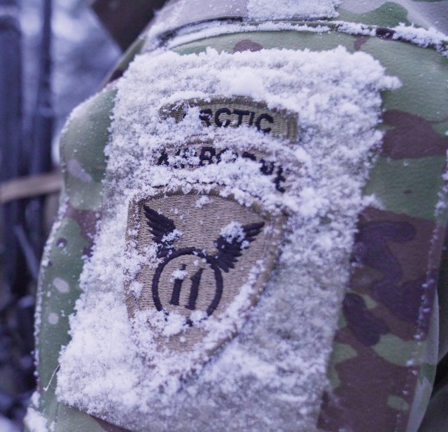 U.S. Army Soldiers assigned to 3rd Battalion, 509th Parachute Infantry Regiment, 2nd Infantry Brigade Combat Team (Airborne), 11th Airborne Division set up in the snow during Joint Pacific Multinational Readiness Center 25-02 in Donnelly Training...