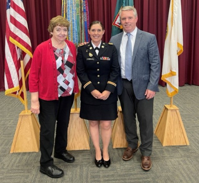 Mary Pavey, left, poses with Hilary Carbajal, command operations specialist, center, and Gregg Thompson, deputy to the commanding general, right, during Carbajal’s promotion ceremony in 2024. Pavey retired July 1, 2025, after 56 years of federal...