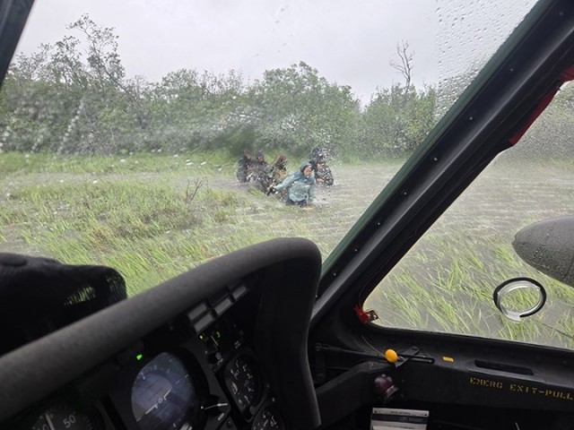 Alaska Army National Guard Chief Warrant Officer 3 Nick Lime, an aviator assigned to 207th Aviation Battalion, assists six distressed people stranded on the Kuskokwim River during a rescue mission June 30, 2025. The Alaska Rescue Coordination...