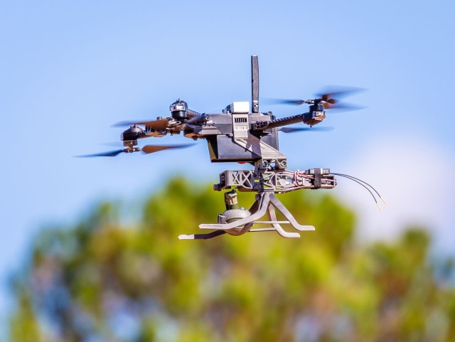An Unmanned Aerial System (UAS) with a U.S. Army Combat Capabilities Development Command Armaments Center's “Audible” dropper to launch a live M67 grenade