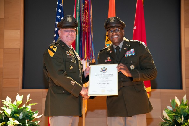 U.S. Army Communications-Electronics Command and APG Senior Commander Maj. Gen. James D. Turinetti IV presents outgoing CECOM Command Chief Warrant Officer Linc W. McCoy with the Department of the Army Certificate of Retirement during a change of...