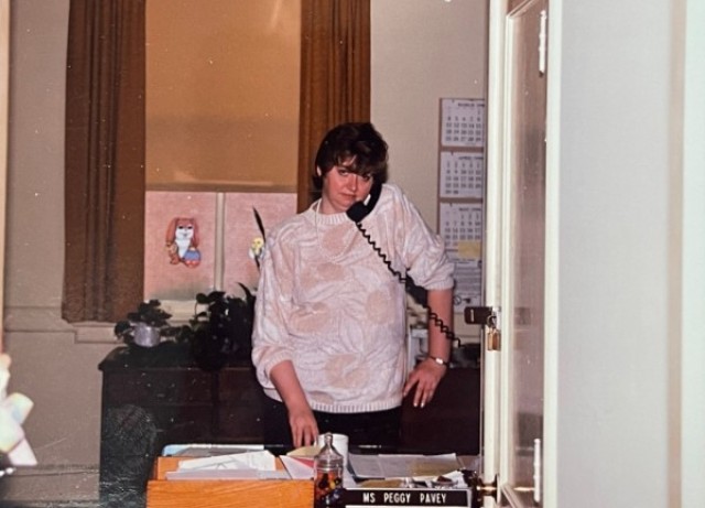 Mary Pavey answers the phone at her desk during the early years of her 56-year career at Fort Leavenworth, Kans. Pavey, who began her federal service in 1969, retired July 1, 2025, as secretary to the deputy to the commanding general.