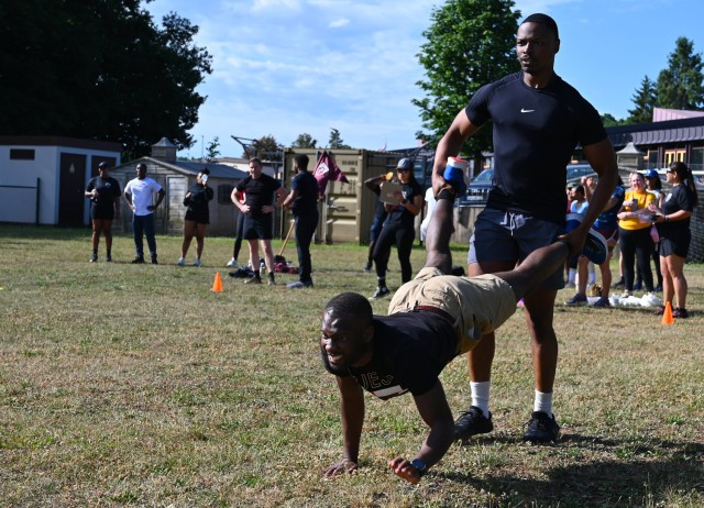 Staff Sgt. Dezmond Simmons and Sgt. Anthony Beckford race as farmer and wheelbarrow respectively in the relay race during the Sembach Kaserne Commander’s Cup 2025. U.S. Army NATO placed third in the relay race and tied for third overall in the...