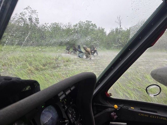 Alaska Army National Guard Chief Warrant Officer 3 Nick Lime, an aviator assigned to 207th Aviation Battalion, assists six distressed people stranded on the Kuskokwim River during a rescue mission June 30, 2025. The Alaska Rescue Coordination...