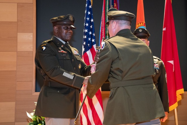 MG James (Jim) D. Turinetti IV passes the ceremonial saber to CW5 Kevin I. Banks, which signifies his trust and confidence in his leadership and commitment to caring for CECOM.