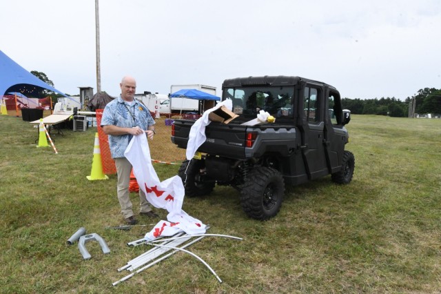 Rich Hughes, Fort Drum emergency manager, sets up a first aid station at a location near the concert stage on Division Hill for Mountainfest on June 26 at Fort Drum. (Photo by Mike Strasser, Fort Drum Garrison Public Affairs)