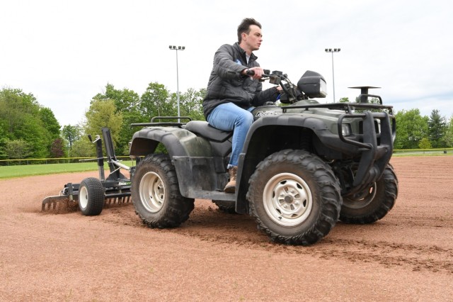 Cole Sullivan, Fort Drum Family and Morale, Welfare and Recreation recreation assistant, rounds the bases to level the playing surface on the ball fields behind Magrath Sports Complex. This was preliminary work in late May, in preparation for the...