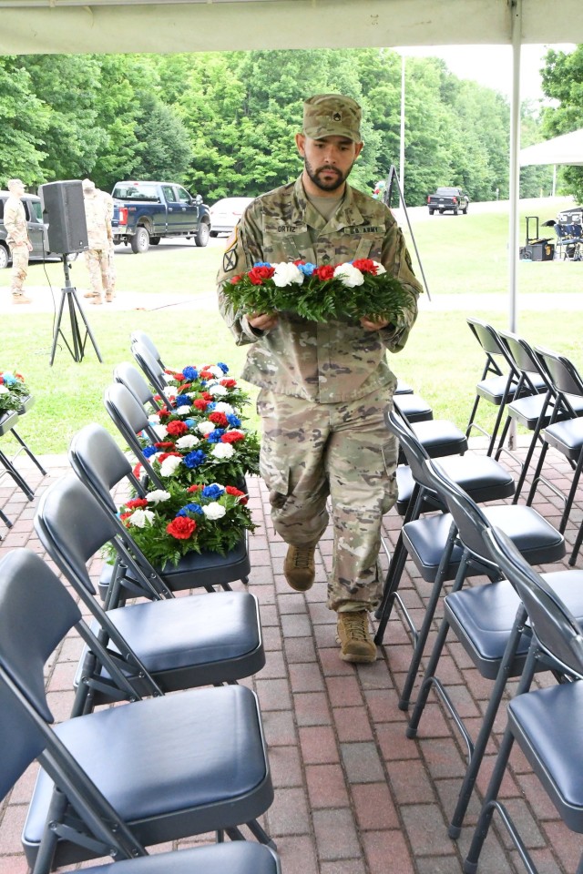 Dozens of 10th Mountain Division (LI) Soldiers set up and rehearse the Annual Remembrance Ceremony in Memorial Park, which includes a color guard, wreath-laying, and a three-volley salute firing party. The ceremony honors the service and...