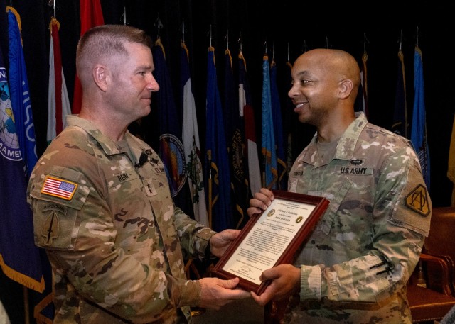 PICATINNY ARSENAL, N.J. - Maj. Gen. John T. Reim (left) passes the Project Lead Joint Services charter to Col. Isaac Cuthbertson (right) during the change of management ceremony on July 1 at Picatinny Arsenal, NJ.