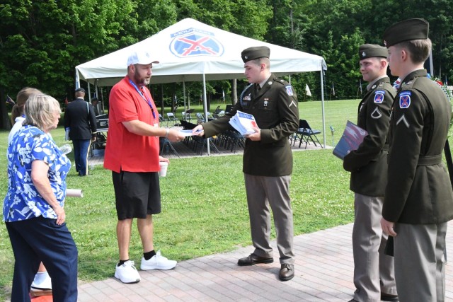 Soldiers from 1st Brigade Combat Team, 10th Mountain Division (LI) welcome guests and hand out programs for the Annual Remembrance Ceremony on June 25 in Memorial Park at Fort Drum. (Photo by Mike Strasser, Fort Drum Garrison Public Affairs)