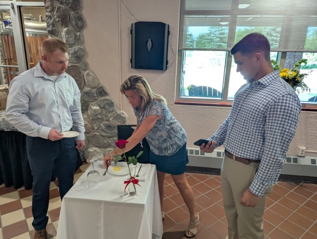 Becky Morgia, Fort Drum FMWR Business and Community Recreation Division chief, polishes silverware for the Fallen Soldier table at the Gold Star evening social at The Ridge on June 24. (Photo by Mike Strasser, Fort Drum Garrison Public Affairs)