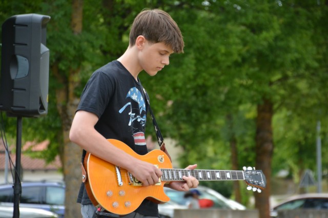 A teenage boy plays electric guitar.