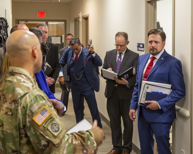 Col. David Stewart, Fort Belvoir Garrison commander, left, briefs Mr. Stephen B. Simmons, Deputy Assistant Secretary of Defense for Military Community and Family Policy (MC&FP), right, for his first foray to a military installation. He capitalized...