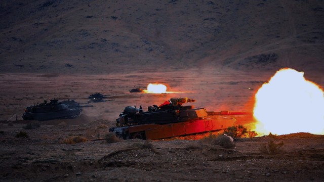 U.S. Army Soldiers assigned to the "Spartan Brigade," 2nd Armored Brigade Combat Team, 3rd Infantry Division, fire from a modernized M1A2 SEPv3 Abrams tanks at the National Training Center, Fort Irwin, California, March 10, 2023. The Spartan...